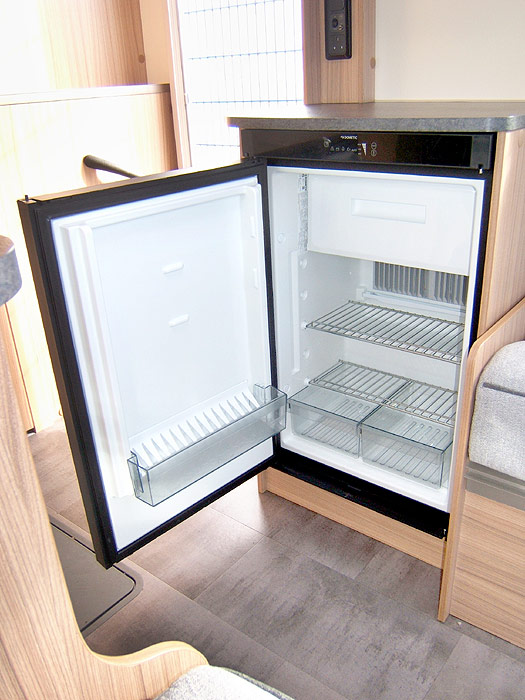 Interior of the high capacity fridge with freezer top box.